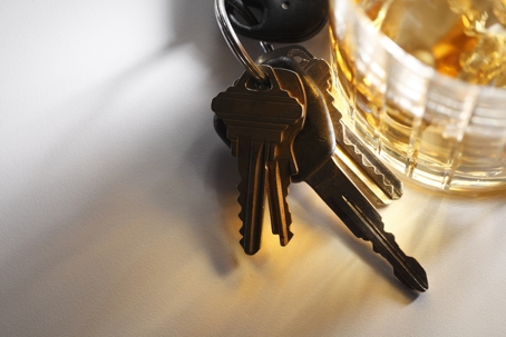 car keys next to a glass of alcohol